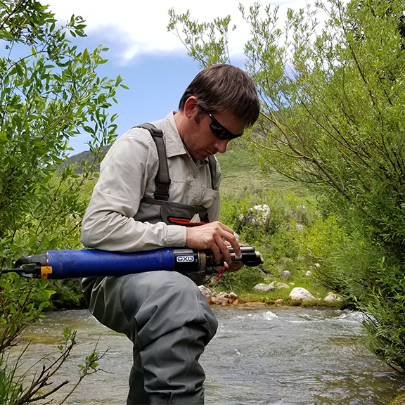 Patrick Strong maintaining LRO sensor in the Logan River